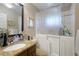 Bright bathroom featuring walk-in tub, granite vanity, and decorative mirrors at 620 Burke Rd, Venice, FL 34293