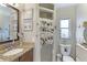 Bathroom featuring a vanity with granite countertop and walk-in closet at 620 Burke Rd, Venice, FL 34293