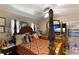 Spacious bedroom with a four-poster bed, dresser, and plenty of natural light at 620 Burke Rd, Venice, FL 34293