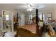 Spacious bedroom with a four-poster bed, dresser, and plenty of natural light at 620 Burke Rd, Venice, FL 34293