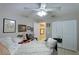 Cozy bedroom featuring a ceiling fan, artwork, closet, and a comfortable bed at 620 Burke Rd, Venice, FL 34293