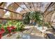 Relaxing outdoor area featuring a covered patio with seating and views of the lush, private backyard space at 620 Burke Rd, Venice, FL 34293