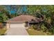 Charming single-story home with a two-car garage and mature landscaping at 620 Burke Rd, Venice, FL 34293
