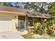 Close-up of the home's entrance with a decorative front porch, lush landscaping, and clearly marked address at 620 Burke Rd, Venice, FL 34293