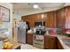 Kitchen with stainless steel appliances, dark wood cabinetry, and granite countertops at 620 Burke Rd, Venice, FL 34293