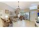 Elegant living room featuring a chandelier, decorative furniture, and neutral wall color at 620 Burke Rd, Venice, FL 34293