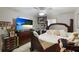 Bedroom featuring a king-size bed, ceiling fan, and neutral color scheme at 620 Burke Rd, Venice, FL 34293
