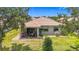 Back exterior shot featuring the patio, beautiful landscape and an eye-catching tile roof at 6240 Falcon Lair Dr, North Port, FL 34287