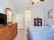 Comfortable bedroom featuring light blue walls, ceiling fan, and wood furniture at 6240 Falcon Lair Dr, North Port, FL 34287