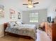 Comfortable bedroom featuring wood floors, a cozy bed, and a rocking chair at 6240 Falcon Lair Dr, North Port, FL 34287