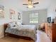 Inviting bedroom with a queen-sized bed, warm wood furnishings, and tasteful coastal-themed decor at 6240 Falcon Lair Dr, North Port, FL 34287