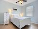 Serene bedroom featuring a white bed, dresser, and ample natural light from the window with bright walls at 6240 Falcon Lair Dr, North Port, FL 34287