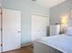 Comfortable bedroom with a closet and a dresser, illuminated by a bedside lamp and natural light at 6240 Falcon Lair Dr, North Port, FL 34287