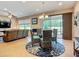Open-concept dining area boasts stylish seating, chandelier lighting, and sliding glass doors to the outdoor space at 6240 Falcon Lair Dr, North Port, FL 34287