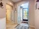 Inviting foyer with a view of the front patio through the decorative glass front door at 6240 Falcon Lair Dr, North Port, FL 34287