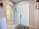 Open foyer with tile flooring, a decorative mirror, and a glimpse of interior doors at 6240 Falcon Lair Dr, North Port, FL 34287