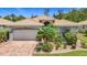 Charming single-story home featuring a beautiful terracotta tile roof, two-car garage, and lush landscaping at 6240 Falcon Lair Dr, North Port, FL 34287