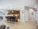 Open kitchen area with an island, bar stool seating, stainless steel appliances, and ample cabinet space at 6240 Falcon Lair Dr, North Port, FL 34287
