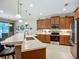 Bright kitchen with marble countertops, island sink, and stainless steel appliances, offering a modern feel at 6240 Falcon Lair Dr, North Port, FL 34287