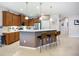 Modern kitchen with pendant lighting, breakfast bar, stainless steel appliances, and ample cabinetry at 6240 Falcon Lair Dr, North Port, FL 34287