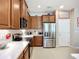 Well-equipped kitchen featuring stainless steel appliances, ample counter space and wooden cabinets at 6240 Falcon Lair Dr, North Port, FL 34287