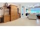 Spacious living room with tile floors, custom shelving and cabinetry, and natural light at 6240 Falcon Lair Dr, North Port, FL 34287