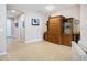 Spacious living area with tiled floors, ample storage, and a view towards the hallway and front entrance at 6240 Falcon Lair Dr, North Port, FL 34287