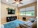 Comfortable living room featuring a plush sofa, large window, mounted TV, and stylish decor at 6240 Falcon Lair Dr, North Port, FL 34287