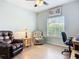 Bright home office with a comfortable chair, desk, and a window offering natural light and green scenery at 6240 Falcon Lair Dr, North Port, FL 34287