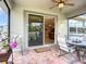 Covered patio features tile flooring, nice furniture and an open sliding door at 6240 Falcon Lair Dr, North Port, FL 34287