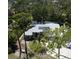 Aerial view of a home featuring a screened-in pool and solar panels at 652 N Elm St, Englewood, FL 34223