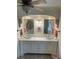 Bathroom featuring a vanity with dual vessel sinks and ornate mirror frames at 652 N Elm St, Englewood, FL 34223