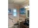 Charming bathroom with pink walls, beach-themed art, and a dark vanity at 652 N Elm St, Englewood, FL 34223