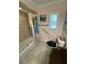Bathroom featuring tiled shower-tub with curtain, grab bar, and shuttered window at 652 N Elm St, Englewood, FL 34223