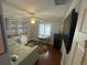 Comfortable bedroom featuring a sitting area, round rug, and mural art of a beachside balcony view at 652 N Elm St, Englewood, FL 34223