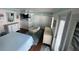 Bright bedroom featuring blue and white decor, papasan chair, and ample storage at 652 N Elm St, Englewood, FL 34223
