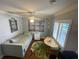 Comfortable guest room with daybed, small dining table, and water-view mural at 652 N Elm St, Englewood, FL 34223