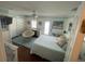 Charming bedroom featuring bright decor, a comfy chair, and a full bed at 652 N Elm St, Englewood, FL 34223