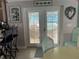 Dining area near kitchen with view to pool through french doors with shutters at 652 N Elm St, Englewood, FL 34223