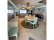 Open dining area with elegant lighting, a round rug, and stylish decor, creating a warm and inviting atmosphere at 652 N Elm St, Englewood, FL 34223