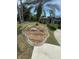 Landscaped front yard featuring decorative rock features, lush green lawn, and a concrete walkway at 652 N Elm St, Englewood, FL 34223