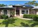 Inviting front door with decorative accents and lush landscaping creates a welcoming entrance at 652 N Elm St, Englewood, FL 34223