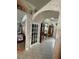 Arched hallway with unique decor details and natural light at 652 N Elm St, Englewood, FL 34223