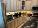 Features traditional cabinets, black granite countertops, and stainless steel appliances at 652 N Elm St, Englewood, FL 34223