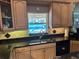 Kitchen featuring a modern sink, updated cabinetry, granite countertops, and a window view, blending style and functionality at 652 N Elm St, Englewood, FL 34223