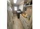 Efficient laundry room with updated appliances, storage, and a wash basin at 652 N Elm St, Englewood, FL 34223
