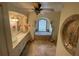Elegant bathroom with garden tub beneath arch window, dual sinks, and walk-in shower at 652 N Elm St, Englewood, FL 34223