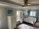 Serene main bedroom features a tray ceiling, plantation shutters, and natural light at 652 N Elm St, Englewood, FL 34223
