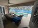 Relaxing covered patio features comfortable seating overlooking the sparkling pool and mural at 652 N Elm St, Englewood, FL 34223