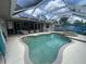 An inviting pool and spa offer the perfect outdoor retreat, complete with ample seating and stylish landscaping at 652 N Elm St, Englewood, FL 34223